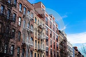 Row of Colorful Old Buildings with Fire Escapes in Harlem of New York City