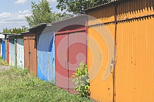 Row of colorful rusty garages or outdoor storage sheds