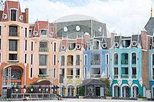 Row of colorful shophouses painted upscale townhome duplex with decorated balcony flower decoration, upscale row of multistory