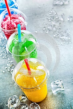 Row of Colorful Slush Drinks in Plastic Cups