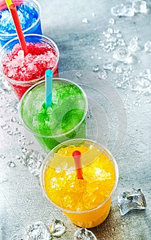 Row of Colorful Slush Drinks in Plastic Cups