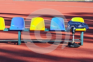 Row of colorful stadium seats and sportsman`s clothes