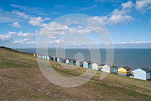 A row of colourful beach huts along the sea front in Tankerton, Whitstable