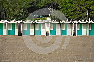 Row of colourful beach huts on a sandy beach