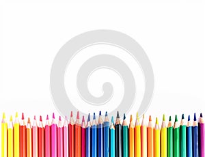 A row of colourful rainbow pencils on a white background