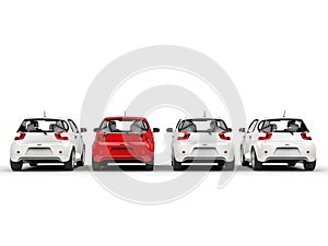 Row of compact cars - red stands out - rear view