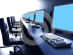 Row of computers on desk photo