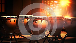 A row of conga drums on stage, lit by warm stage lights with a bokeh effect. Ideal for music-themed projects and