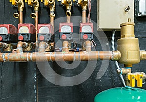 Row of copper pipes with control unit