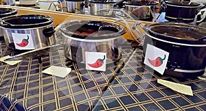 Row of crock pots in chili cook-off contest