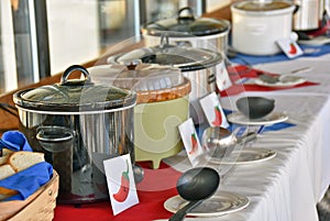 Row of crock pots in chili cook off contest