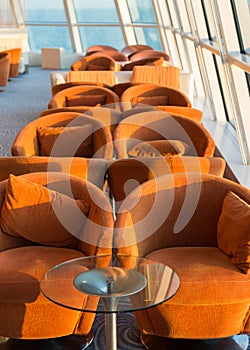 Row of cushioned seats or chairs by windows