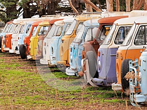 Row of defunct colorful and run down desolate vans