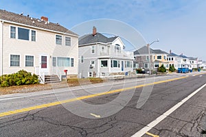 Row of detached houses along a coastal highway in autumn