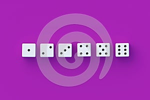 Row of dices on violet background. Top view