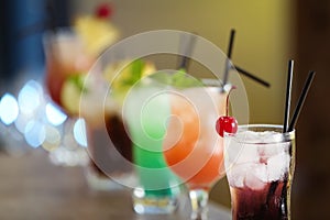 Row of different fresh alcoholic cocktails