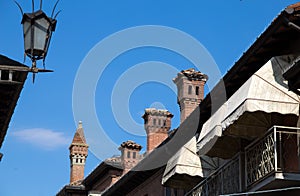 Row of different stone chimneys on the roof of an Italian house, Italy