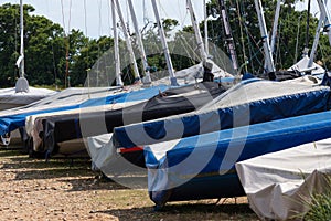 Row of Dinghy sailing boats