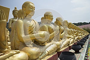 Row of disciple statues surrounding Big buddha statue