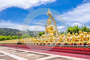 Row of disciple statues surrounding big buddha statue in public to the general public worship worship, Thailand