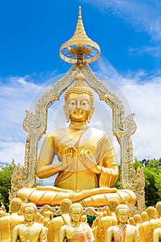 Row of disciple statues surrounding big buddha statue in public to the general public worship worship