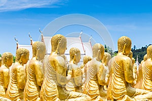 Row of disciple statues surrounding big buddha statue in public to the general public worship worship