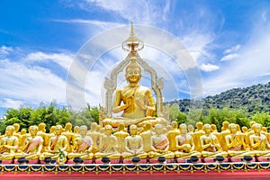 Row of disciple statues surrounding big buddha statue in public to the general public worship worship, Thailand
