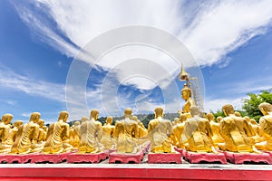 Row of disciple statues surrounding big buddha statue in public to the general public worship worship, Thailand