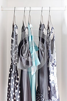 Row of dress hanging on coat hanger in wardrobe