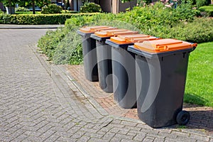 Row of dutch grey waste bins along street