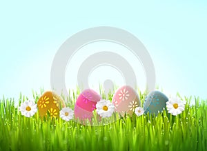 Row of Easter eggs in Fresh Green Grass