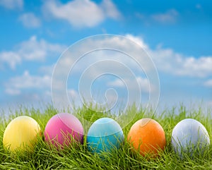 Row of easter eggs in grass photo