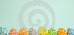 Row Easter eggs with spring light blue background