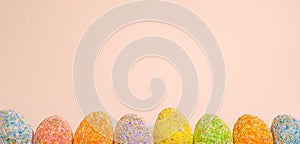 Row Easter eggs with spring light pink background