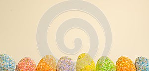 Row Easter eggs with spring light yellow background