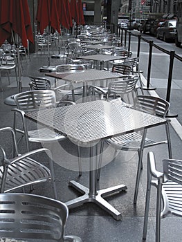 Row of empty metal tables and chairs