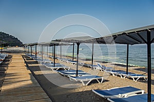 Row of empty sun loungers on the beach in Kemer Antalya