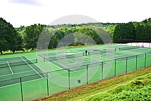 A Row of Empty Tennis Courts photo