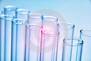 Row of empty test tubes blue background