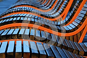 A row of empty wooden benches from reeks in the city park close-up, abstraction