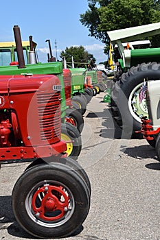 Row of Farmall and John Deere tractors