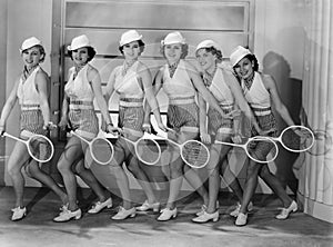 Row of female tennis players in matching outfits
