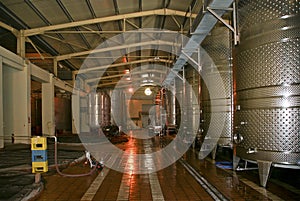 A row of fermenters inside a modern winery