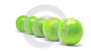 Five green limes on white background