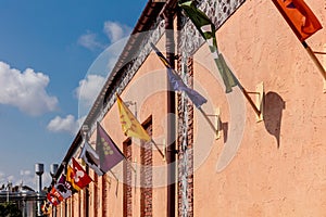 A row of flags hanging from a building