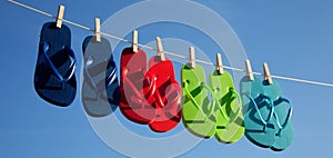 Row of flipflops against a blue sky