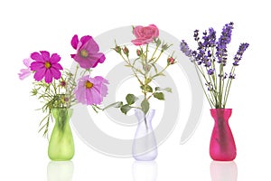 Row flowers in little vases