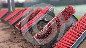 A row of football boot mud scraper brushes