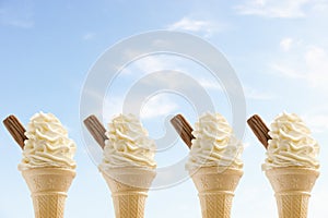 Row of four icecreams against sky