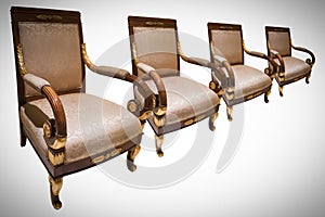 Row of four vintage chairs isolated on white